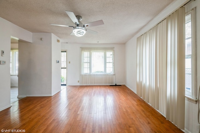 14841 Langley Ave, Dolton, IL 60419 - spare room featuring a ceiling fan, a textured ceiling, and light wood-style floors