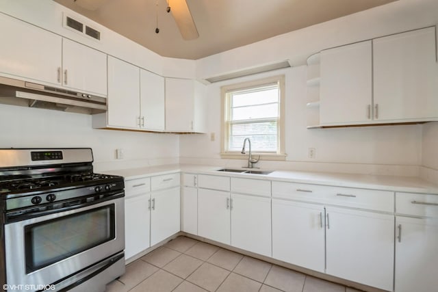 14841 Langley Ave, Dolton, IL 60419 - kitchen with stainless steel gas range oven, under cabinet range hood, white cabinetry, light countertops, and light tile patterned floors