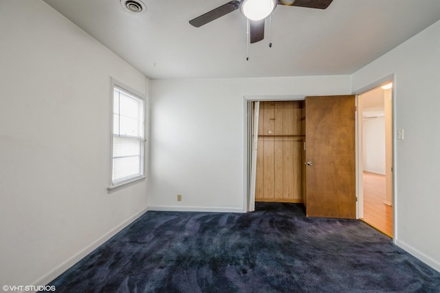 14841 Langley Ave, Dolton, IL 60419 - unfurnished bedroom with dark carpet, a closet, and ceiling fan
