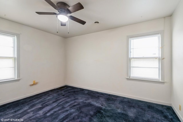 14841 Langley Ave, Dolton, IL 60419 - spare room featuring dark carpet, plenty of natural light, and a ceiling fan