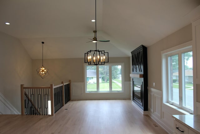 5660 W 83rd Pl, Burbank, IL 60459 - unfurnished living room featuring a chandelier, light wood-type flooring, healthy amount of natural light, a decorative wall, and wainscoting