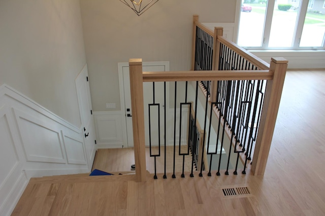 5660 W 83rd Pl, Burbank, IL 60459 - staircase with wood finished floors, a decorative wall, and a wainscoted wall