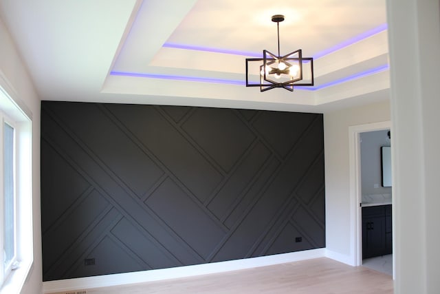 5660 W 83rd Pl, Burbank, IL 60459 - detailed view of a decorative wall, a raised ceiling, a chandelier, and wood finished floors