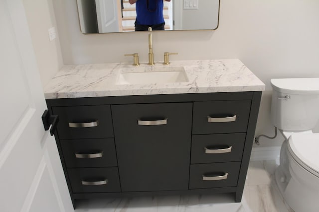 5660 W 83rd Pl, Burbank, IL 60459 - bathroom featuring toilet, vanity, and marble look tiles