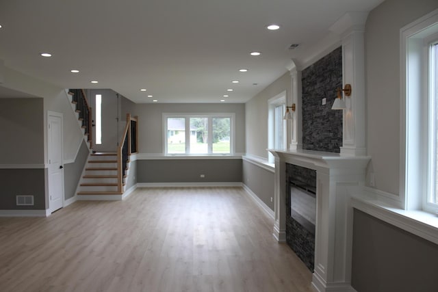 5660 W 83rd Pl, Burbank, IL 60459 - unfurnished living room with a large fireplace, recessed lighting, light wood-style floors, stairs, and baseboards