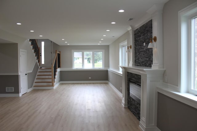 5660 W 83rd Pl, Burbank, IL 60459 - unfurnished living room featuring recessed lighting, a large fireplace, light wood-type flooring, stairs, and baseboards