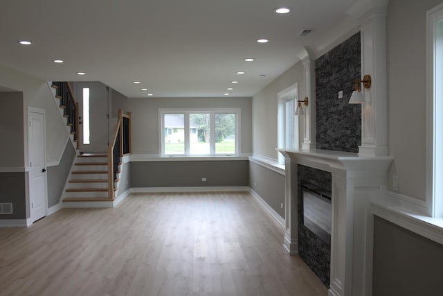 5660 W 83rd Pl, Burbank, IL 60459 - unfurnished living room with a large fireplace, light wood-type flooring, stairs, recessed lighting, and baseboards