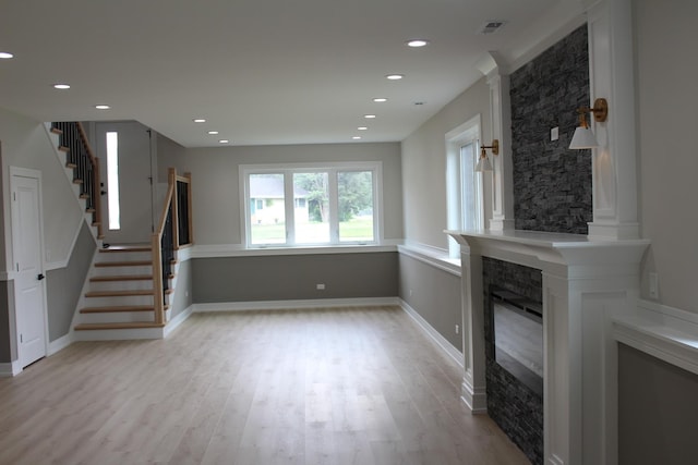 5660 W 83rd Pl, Burbank, IL 60459 - unfurnished living room featuring a glass covered fireplace, stairway, light wood finished floors, recessed lighting, and baseboards