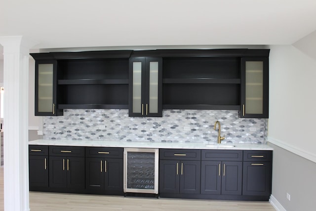 5660 W 83rd Pl, Burbank, IL 60459 - bar area with wine cooler, a sink, light wood-style floors, and decorative backsplash