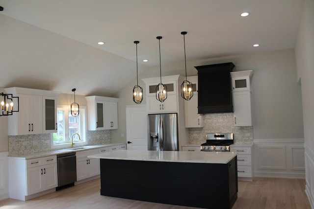 5660 W 83rd Pl, Burbank, IL 60459 - kitchen featuring appliances with stainless steel finishes, a sink, a chandelier, a center island, and light wood-style flooring