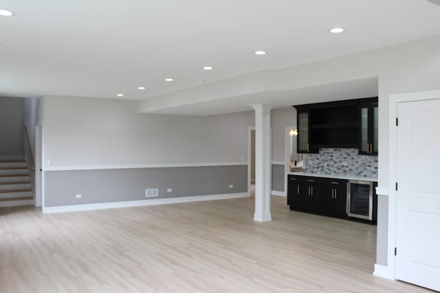 5660 W 83rd Pl, Burbank, IL 60459 - unfurnished living room featuring light wood-style floors, beverage cooler, stairway, recessed lighting, and baseboards
