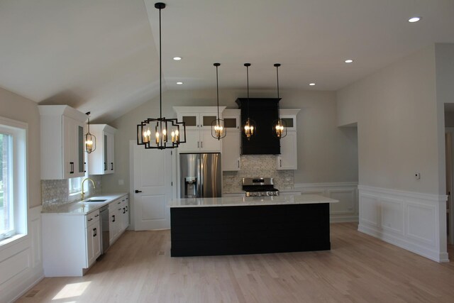 5660 W 83rd Pl, Burbank, IL 60459 - kitchen featuring stainless steel appliances, a chandelier, light wood-type flooring, backsplash, and a wainscoted wall