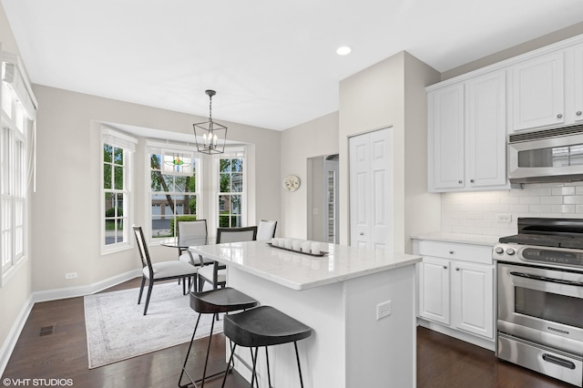 65 S Asbury Ct, Lake Forest, IL 60045 - kitchen with appliances with stainless steel finishes, a center island, backsplash, dark wood finished floors, and white cabinetry