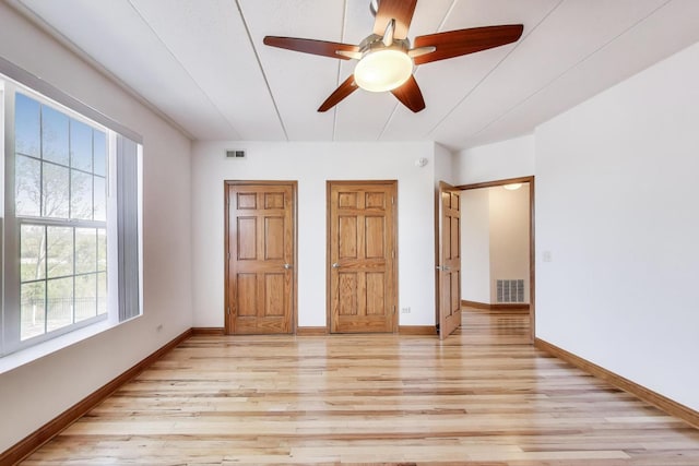 16671 Liberty Cir Unit 2N, Orland Park, IL 60467 - unfurnished bedroom featuring light wood finished floors, multiple windows, and a ceiling fan