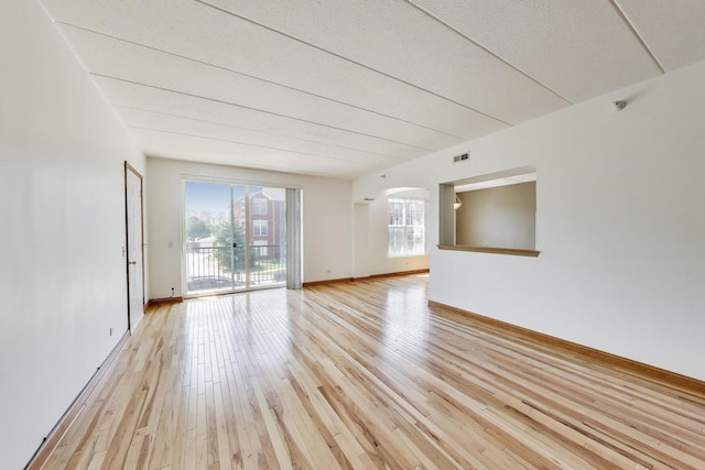 16671 Liberty Cir Unit 2N, Orland Park, IL 60467 - unfurnished room featuring light wood-style floors, arched walkways, and a textured ceiling