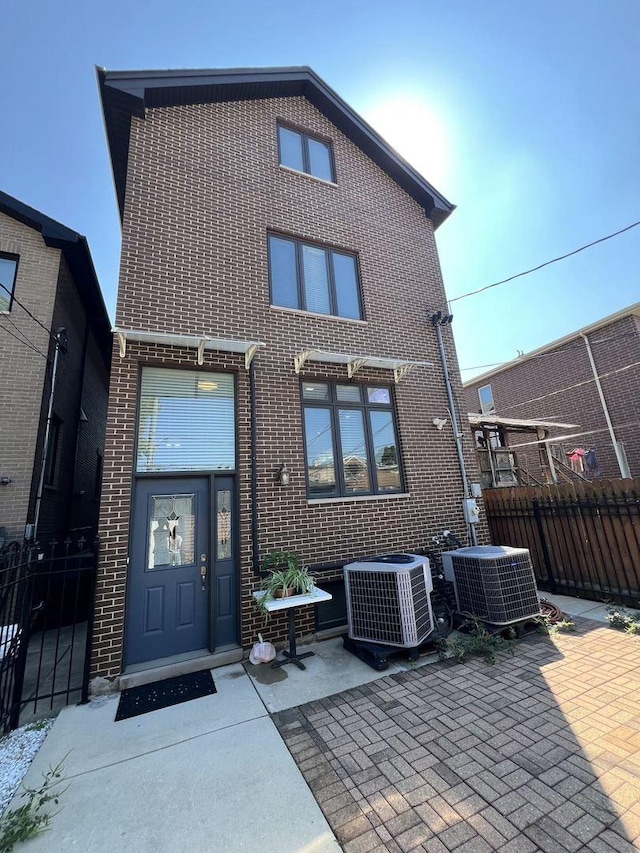 3004 S Canal St, Chicago, IL 60616 - back of house with cooling unit, brick siding, and a patio area