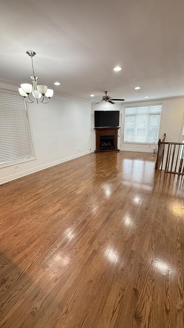3004 S Canal St, Chicago, IL 60616 - unfurnished living room with recessed lighting, a chandelier, ceiling fan, wood finished floors, and a fireplace