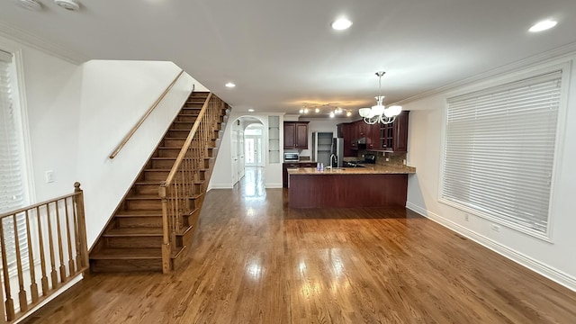3004 S Canal St, Chicago, IL 60616 - kitchen with a peninsula, arched walkways, wood finished floors, baseboards, and recessed lighting