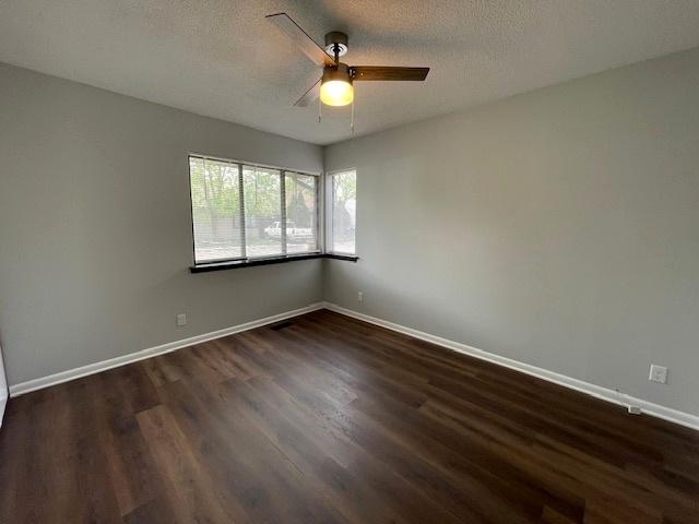 211 W Birchwood Dr Unit 211, Romeoville, IL 60446 - spare room featuring a ceiling fan, dark wood-type flooring, baseboards, and a textured ceiling