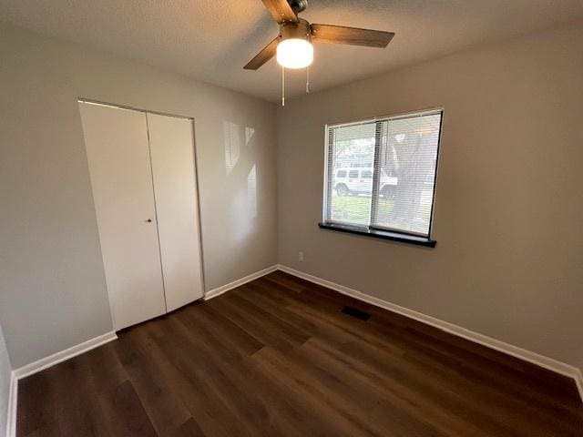 211 W Birchwood Dr Unit 211, Romeoville, IL 60446 - unfurnished bedroom featuring wood finished floors, baseboards, a closet, and ceiling fan