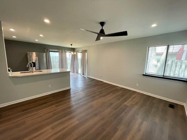 211 W Birchwood Dr Unit 211, Romeoville, IL 60446 - unfurnished living room featuring baseboards, dark wood finished floors, recessed lighting, ceiling fan, and a sink
