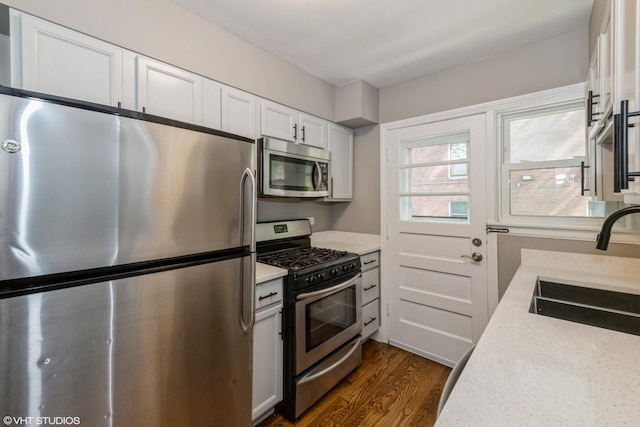 226 S Maple Ave Unit F, Oak Park, IL 60302 - kitchen with appliances with stainless steel finishes, dark wood-type flooring, white cabinetry, and light stone counters