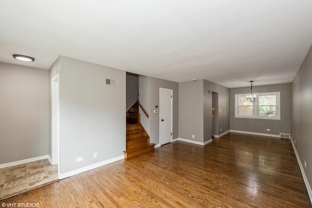 226 S Maple Ave Unit F, Oak Park, IL 60302 - unfurnished room featuring a chandelier, stairs, and wood finished floors