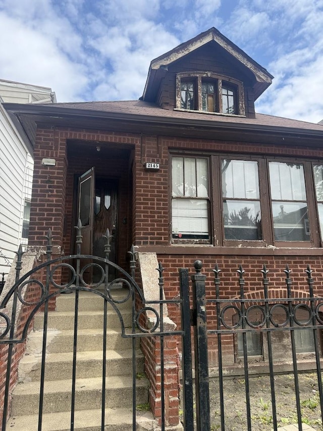 2145 N Karlov Ave, Chicago, IL 60639 - doorway to property featuring brick siding and a gate