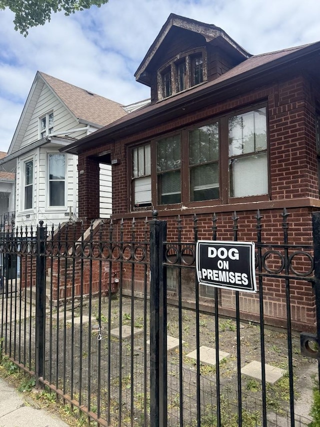 2145 N Karlov Ave, Chicago, IL 60639 - view of front of house featuring a fenced front yard, brick siding, and a shingled roof