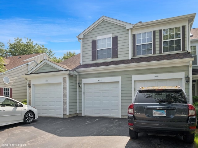 45 Tyler Ct Unit A, Streamwood, IL 60107 - view of front of property with driveway, a garage, and a shingled roof