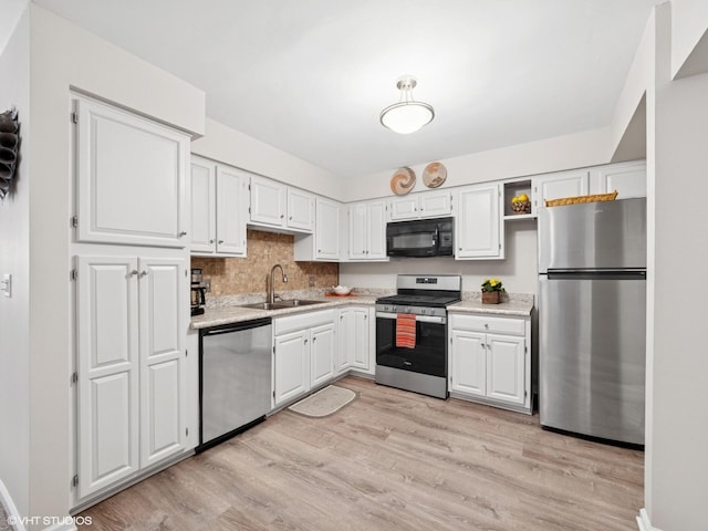 45 Tyler Ct Unit A, Streamwood, IL 60107 - kitchen with stainless steel appliances, a sink, light countertops, and light wood-style flooring