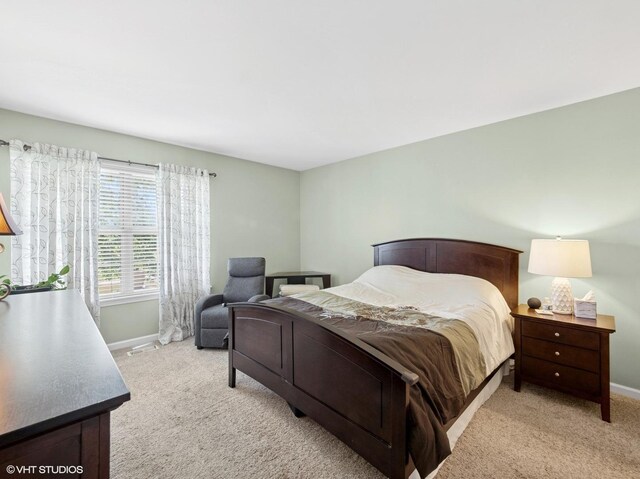 45 Tyler Ct Unit A, Streamwood, IL 60107 - bedroom with light colored carpet and baseboards