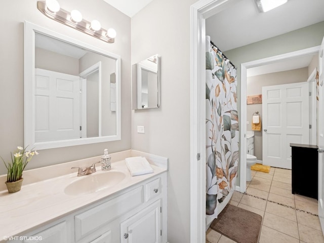 45 Tyler Ct Unit A, Streamwood, IL 60107 - bathroom featuring vanity, tile patterned floors, toilet, and a shower with shower curtain