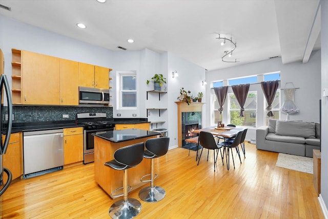 2744 W Haddon Ave Unit 2, Chicago, IL 60622 - kitchen with appliances with stainless steel finishes, open shelves, light wood-type flooring, dark countertops, and recessed lighting