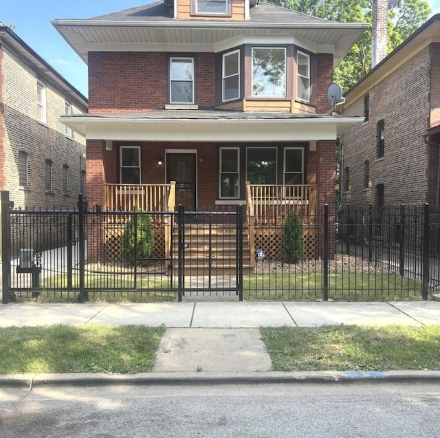 2627 E 74th Pl, Chicago, IL 60649 - american foursquare style home with a porch, brick siding, a fenced front yard, and roof with shingles