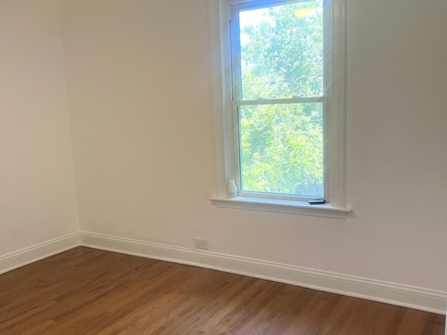 2627 E 74th Pl, Chicago, IL 60649 - unfurnished room featuring baseboards and dark wood-style flooring