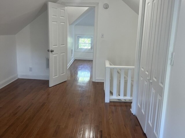 2627 E 74th Pl, Chicago, IL 60649 - bonus room with vaulted ceiling, dark wood-style flooring, and baseboards