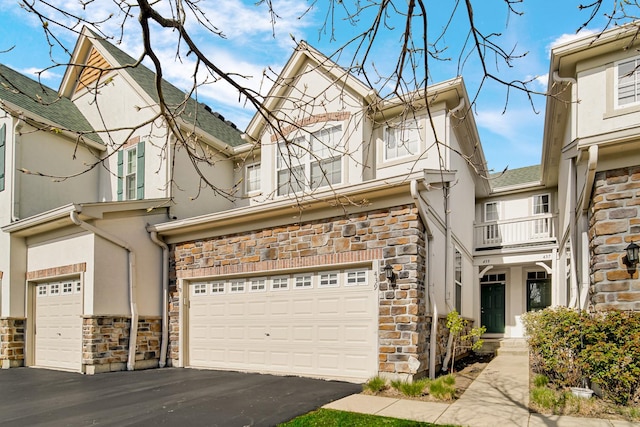 439 Bay Tree Cir, Vernon Hills, IL 60061 - view of front of home with stone siding, stucco siding, a garage, asphalt driveway, and roof with shingles