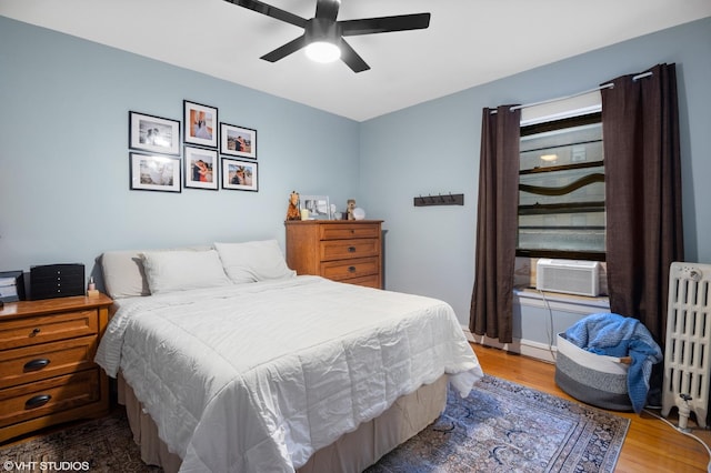 2017 W Farragut Ave Unit 1, Chicago, IL 60625 - bedroom with radiator heating unit, wood finished floors, cooling unit, and a ceiling fan
