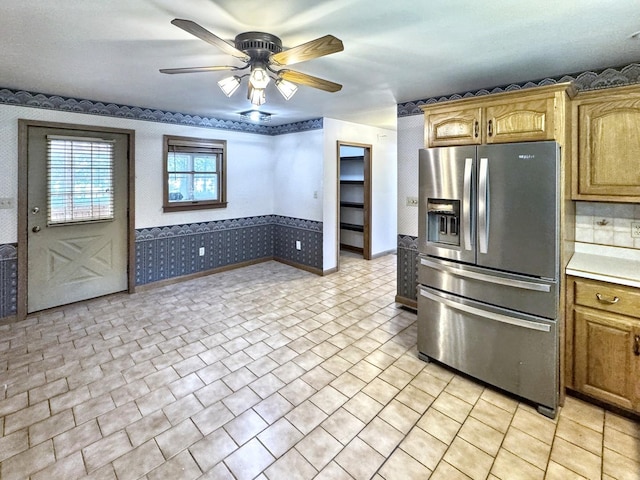 1204 W Reynolds St, Pontiac, IL 61764 - kitchen with stainless steel refrigerator with ice dispenser, wallpapered walls, ceiling fan, light countertops, and baseboards