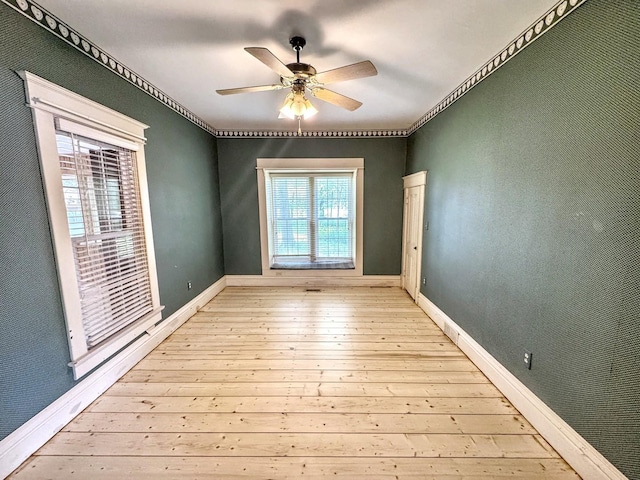 1204 W Reynolds St, Pontiac, IL 61764 - spare room featuring hardwood / wood-style flooring, ornamental molding, ceiling fan, and baseboards