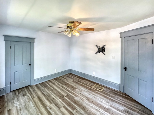 1204 W Reynolds St, Pontiac, IL 61764 - unfurnished room featuring a ceiling fan, wood finished floors, and baseboards