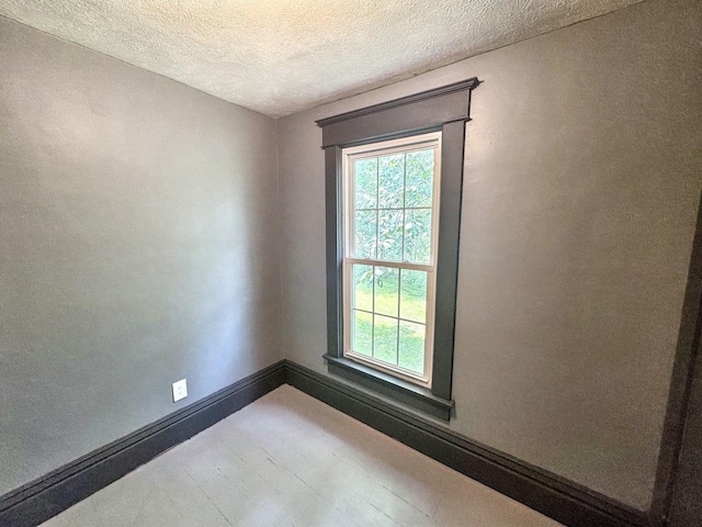 1204 W Reynolds St, Pontiac, IL 61764 - unfurnished room with a textured ceiling and baseboards