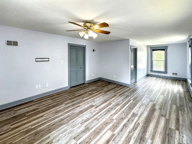 1204 W Reynolds St, Pontiac, IL 61764 - empty room featuring a ceiling fan, wood finished floors, and baseboards