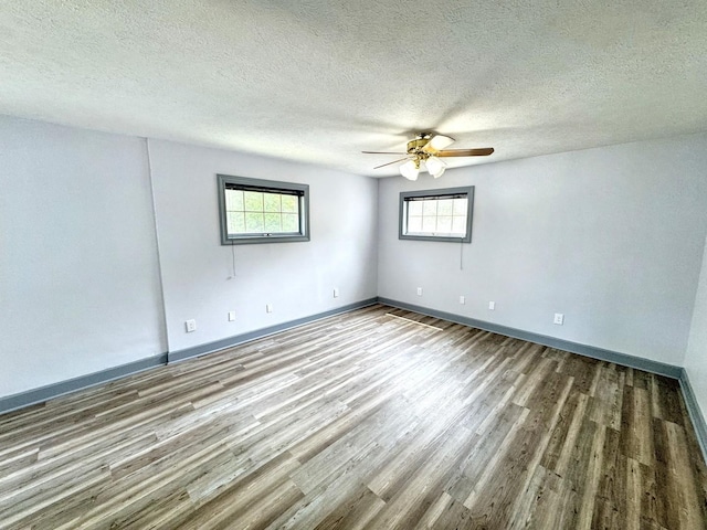 1204 W Reynolds St, Pontiac, IL 61764 - unfurnished room featuring wood finished floors, a ceiling fan, healthy amount of natural light, baseboards, and a textured ceiling
