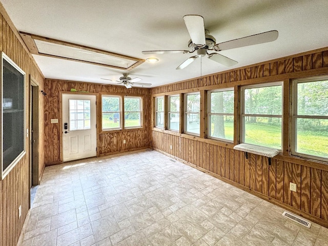 1204 W Reynolds St, Pontiac, IL 61764 - unfurnished sunroom featuring wooden walls, baseboards, and stone finish flooring