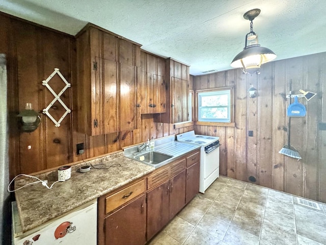 1204 W Reynolds St, Pontiac, IL 61764 - kitchen with white range with electric cooktop, a sink, wooden walls, pendant lighting, and a textured ceiling