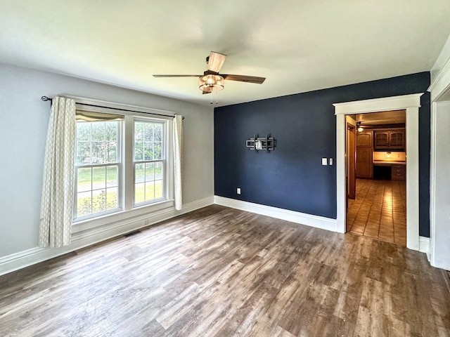 1204 W Reynolds St, Pontiac, IL 61764 - spare room featuring wood finished floors, ceiling fan, and baseboards