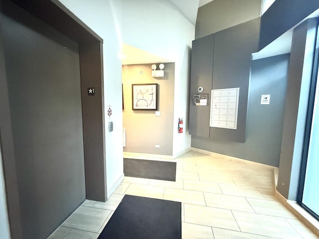 4770 N Manor Ave Unit 405, Chicago, IL 60625 - hall with elevator, light tile patterned floors, and baseboards