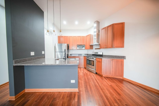 4770 N Manor Ave Unit 405, Chicago, IL 60625 - kitchen with appliances with stainless steel finishes, wall chimney range hood, light wood-type flooring, a peninsula, and dark stone countertops